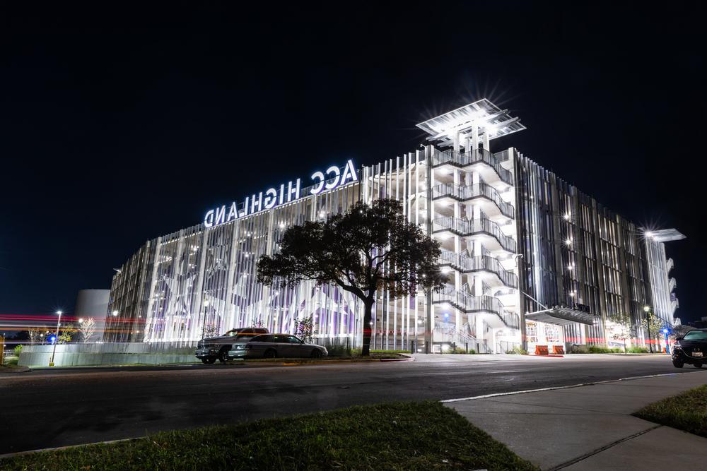 ACC Highland campus at night with white lights.